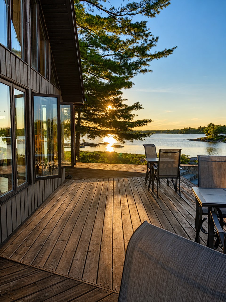 Deck chairs overlooking the water at sunset