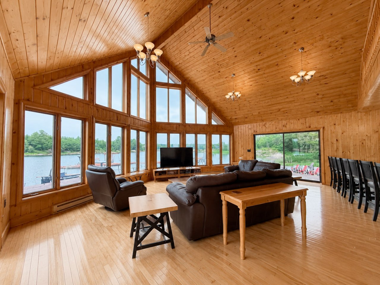 A-frame great room — soaring cathedral ceiling, wall of windows facing the bay
