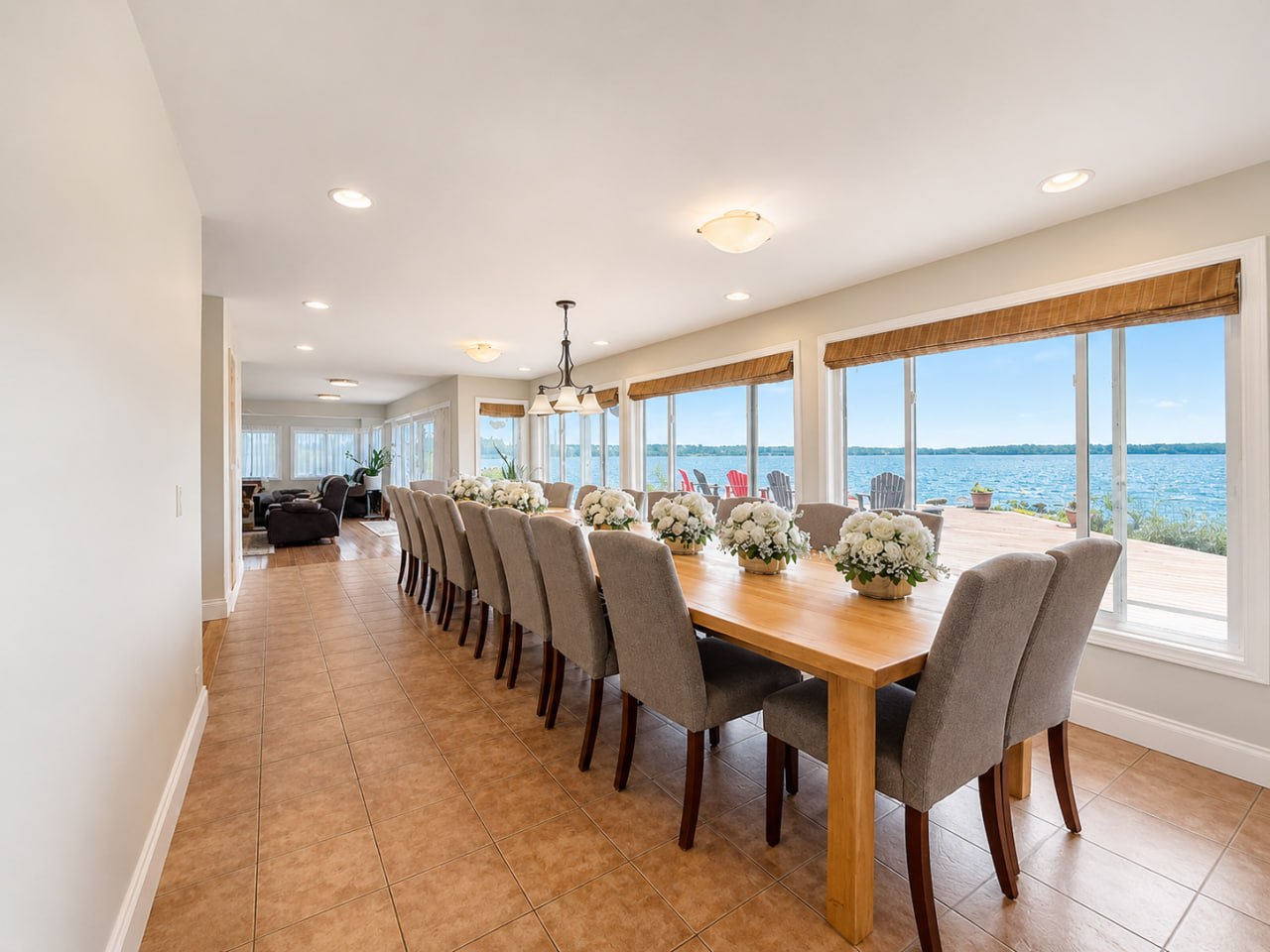 Grand 16-seat dining room with wall of windows facing Georgian Bay